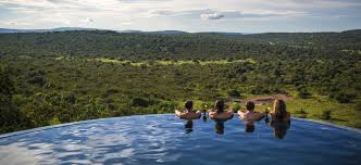 Mihingo Lodge features luxury safari tents with thatched roofs